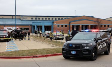 Law enforcement officers work at the scene of a shooting at Perry High School in Perry