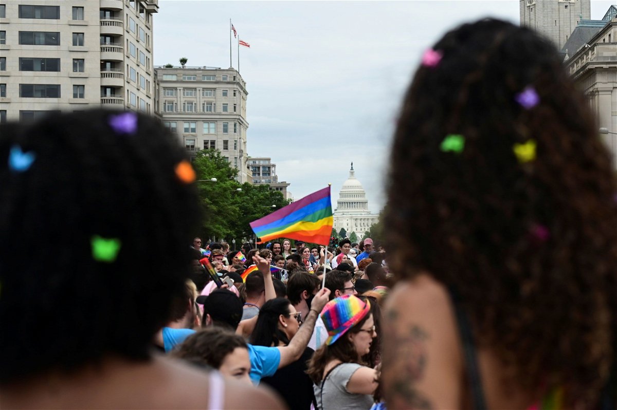 <i>Erin Scott/Reuters</i><br/>The US Capitol building is seen in the background as people attend a LGBTQ + Pride event in Washington