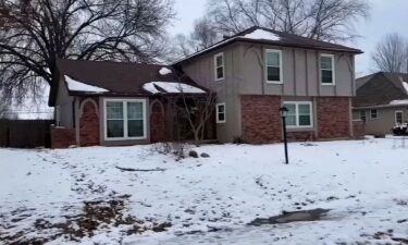 The men's bodies were found in the back yard of this house in northern Kansas City.