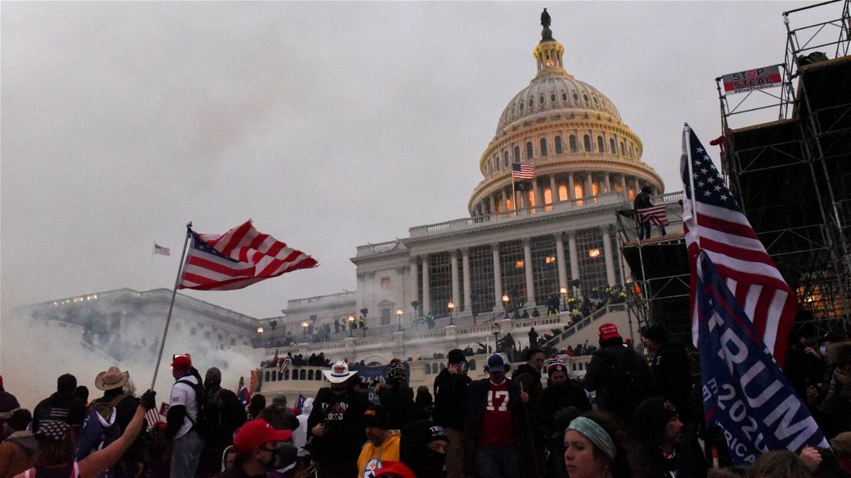 <i>Stephanie Keith/Reuters</i><br/>Police clear the U.S. Capitol Building with tear gas as supporters of U.S. President Donald Trump gather outside