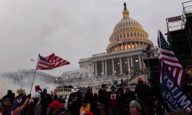 Police clear the U.S. Capitol Building with tear gas as supporters of U.S. President Donald Trump gather outside