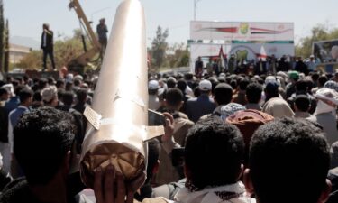 Yemenis lift a mock missile at a protest against the US-led airstrikes on Yemen.