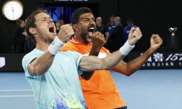 Rohan Bopanna and Matthew Ebden celebrate winning the men's doubles final at the Australian Open.