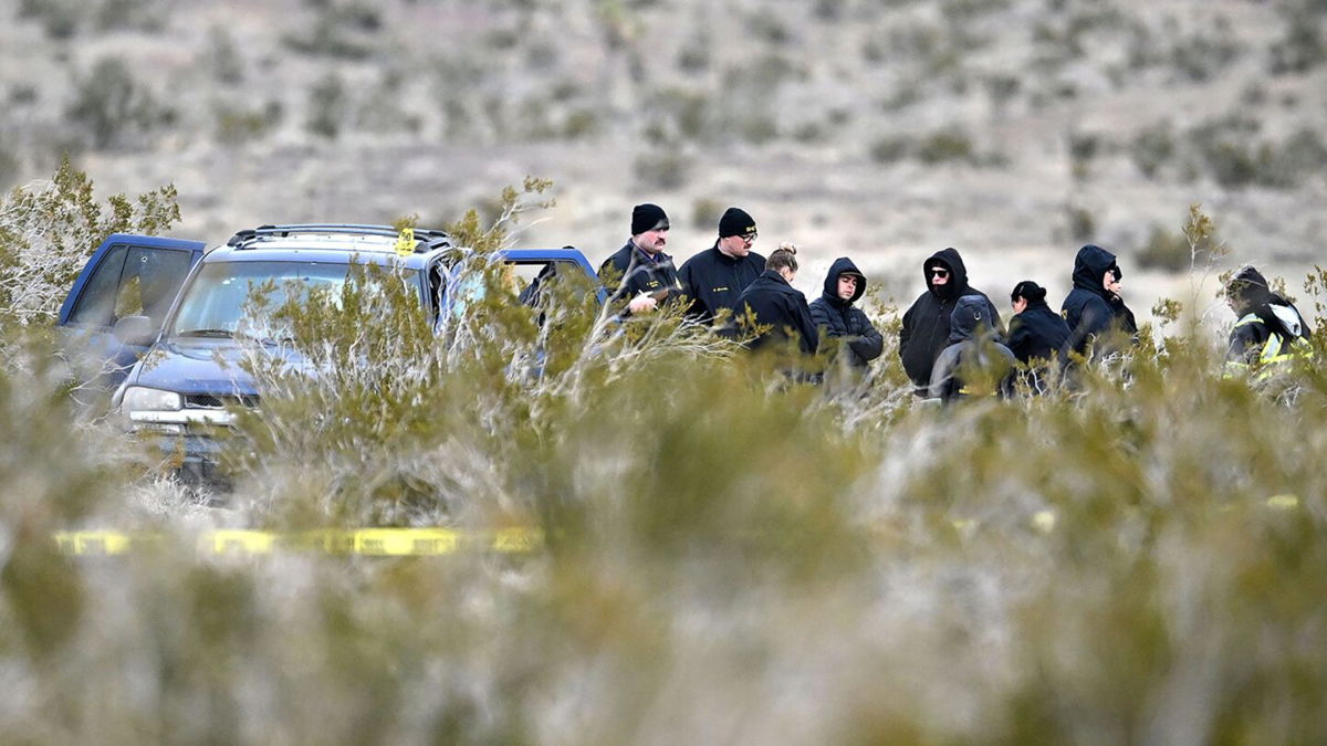 <i>Will Lester/MediaNews Group/Inland Valley Daily Bulletin/Getty Images</i><br/>Investigators with the San Bernardino County Sheriff's Department investigate after six bodies were discovered on a dirt road in the Mojave Desert in El Mirage