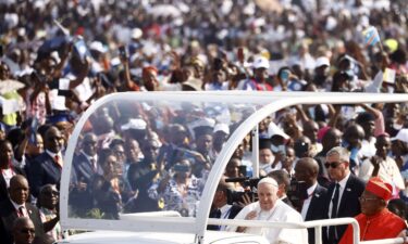 Pope Francis (C) arrives by popemobile for a meeting with young people and catechists at Martyrs' Stadium in Kinshasa