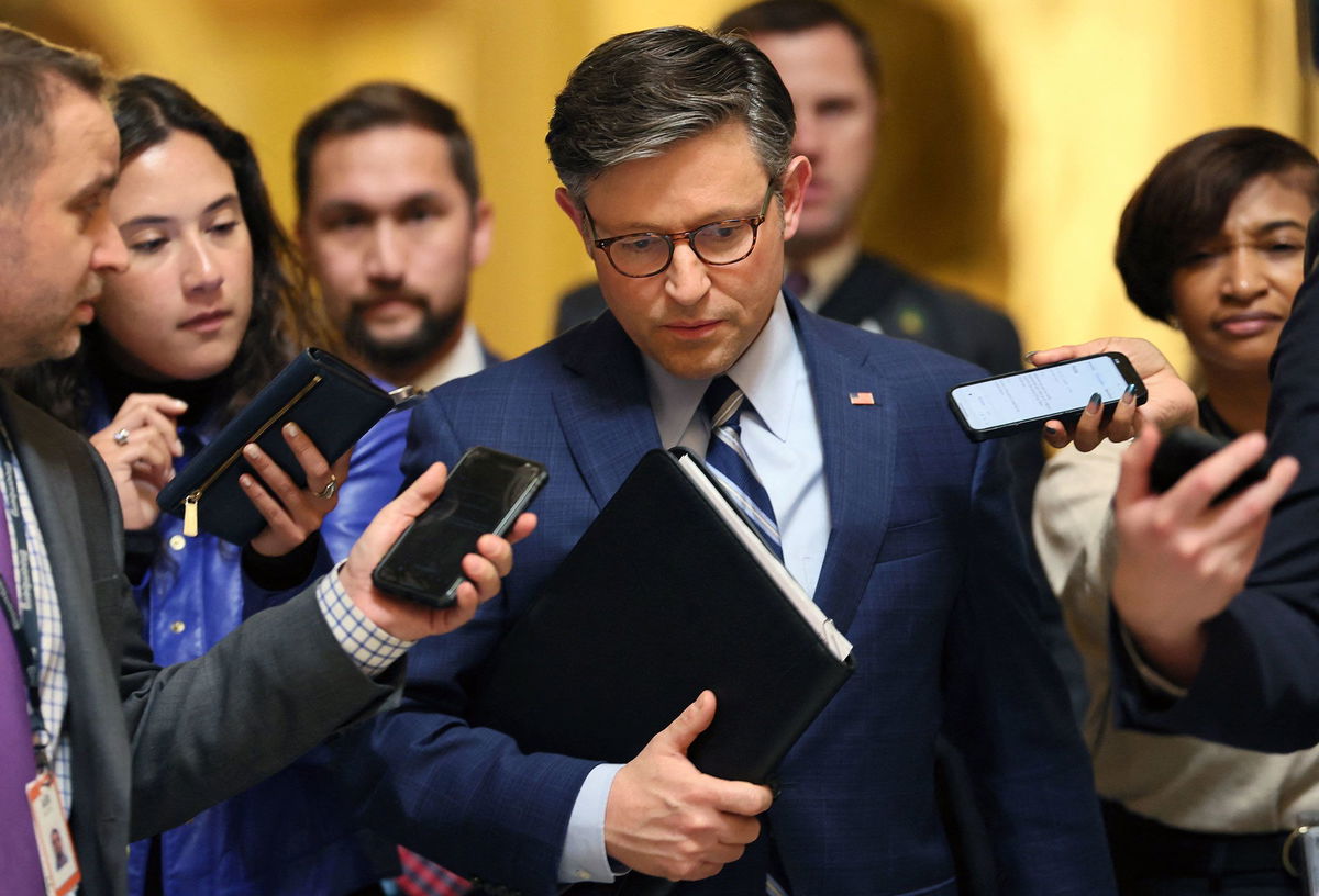 <i>Leah Millis/Reuters</i><br/>Members of the news media ask Speaker Mike Johnson questions as he walks to his office in the Capitol building in Washington