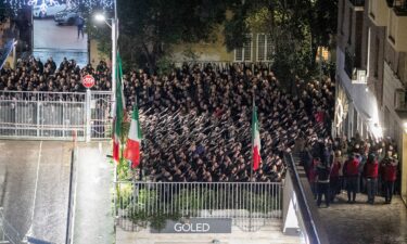 People appear to give the banned fascist salute during a rally to commemorate the slaying in 1978 of two members of a neo-fascist youth group in an attack later claimed by extreme-left militants