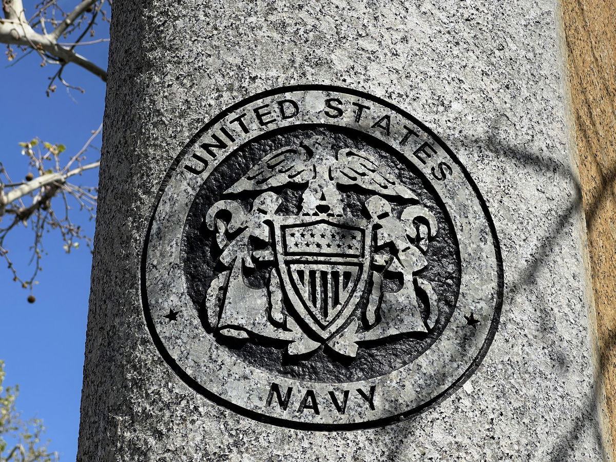 <i>Smith Collection/Gado/Archive Photos/Getty Images</i><br/>United States Navy emblem on a circular surface with surrounding trees