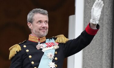 Denmark's King Frederik X waves from the balcony of Christiansborg Palace in Copenhagen