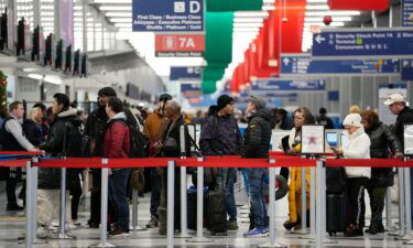 Travelers wait to go through security check point at the O'Hare International Airport in Chicago
