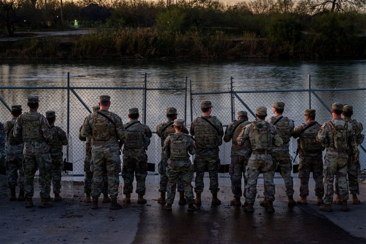 <i>Brandon Bell/Getty Images</i><br/>National Guard soldiers stand guard on January 12 on the banks of the Rio Grande at Shelby Park in Eagle Pass