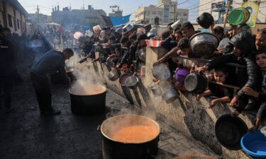 People wait for food relief in the southern Gaza Strip city of Rafah