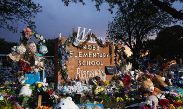 The sun sets behind the memorial for the victims of the massacre at Robb Elementary School on August 24