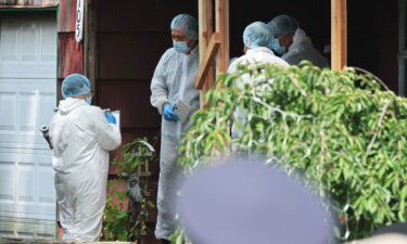 Law enforcement officials are seen at the home of a suspect arrested in the unsolved Gilgo Beach killings on July 14