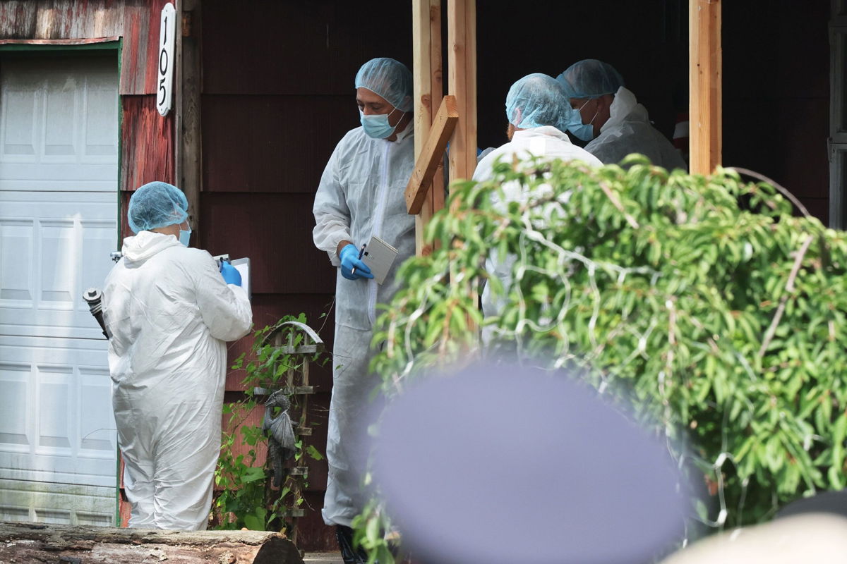 <i>Michael M. Santiago/Getty Images</i><br/>Law enforcement officials are seen at the home of a suspect arrested in the unsolved Gilgo Beach killings on July 14