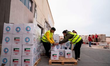 Members of the Egyptian Red Crescent and civil organizations work to mobilize aid in the Egyptian Red Crescent warehouse in preparation for its entry into the Gaza Strip after the Security Council's decision to increase the entry of aid to Gaza on January 17 in Rafah