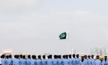 Members of the Pakistan Air Force (PAF) stand in formation during the national anthem