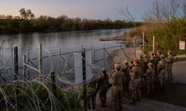 National Guard soldiers stand guard on the banks of the Rio Grande river at Shelby Park on January 12 in Eagle Pass