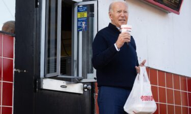 President Joe Biden holds a milkshake during a quick stop at Cook Out