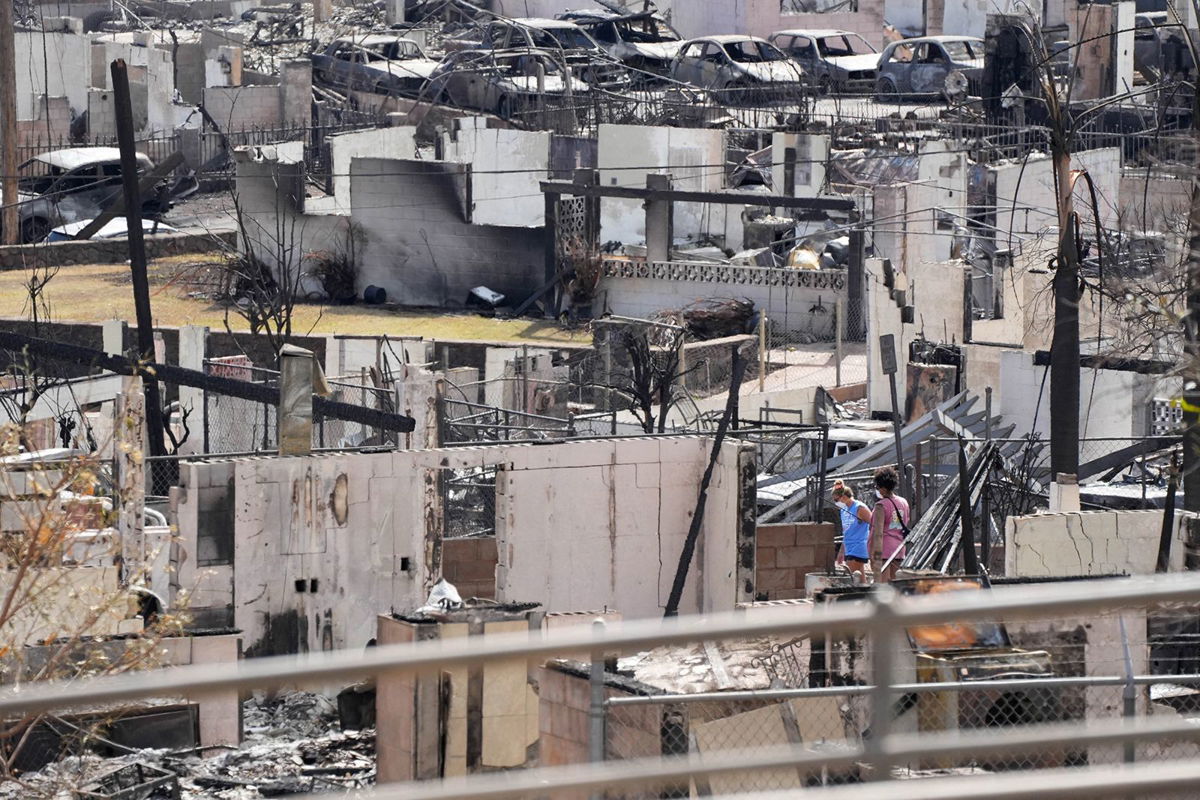 <i>Sandy Hooper/USA TODAY/Reuters</i><br/>Two people examine a burned house on August 13