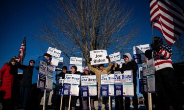 Attendees hold signs during a Write-In Joe Biden campaign "Get Out The Vote" event in Dover