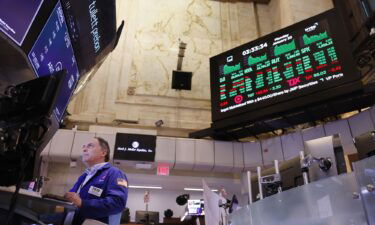 Traders are pictured working on the floor of the New York Stock Exchange during afternoon trading on January 22. The Dow crossed the 38