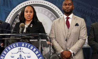 Fulton County District Attorney Fani Willis speaks at a news conference next to prosecutor Nathan Wade in Atlanta on August 14