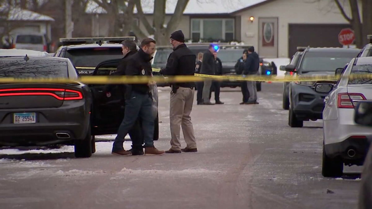 <i>WLS</i><br/>Police gather near the crime scene where seven people were found dead in Joliet