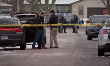 Police gather near the crime scene where seven people were found dead in Joliet