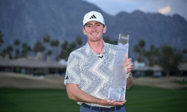 Nick Dunlap poses with the trophy after winning The American Express tournament on Sunday.