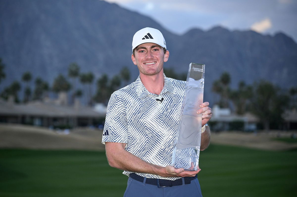 <i>Orlando Ramirez/Getty Images</i><br/>Nick Dunlap poses with the trophy after winning The American Express tournament on Sunday.