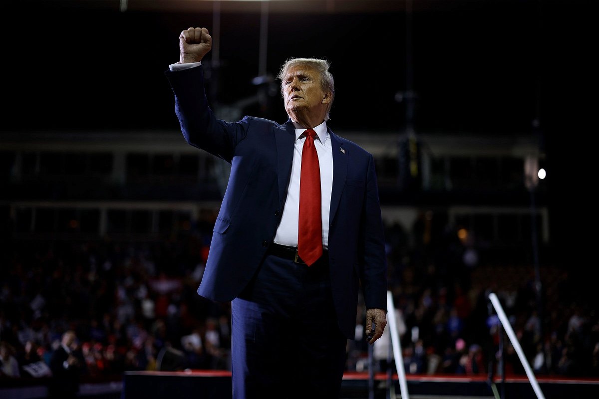 Former President Donald Trump acknowledges supporters as he leaves the stage at the conclusion of a campaign rally at the SNHU Arena on January 20