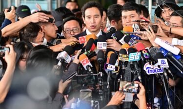 A supporter of former Thai prime ministerial candidate and ex-Move Forward Party leader Pita Limjaroenrat celebrates outside the Constitutional Court in Bangkok on January 24 after the court decided to reinstate him as a lawmaker.