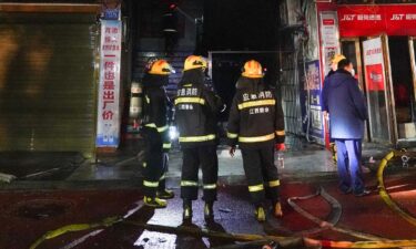 Firefighters work at the site of a shop fire in China's southeastern city of Xinyu on January 24.