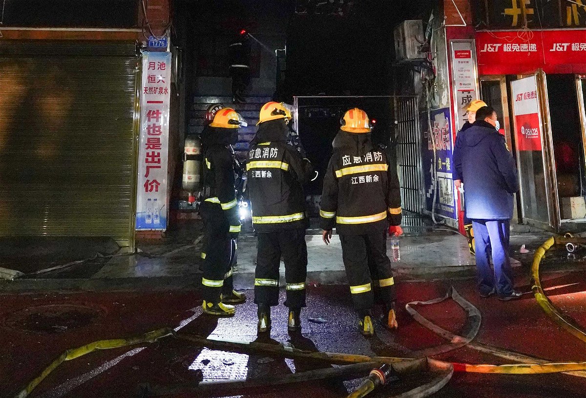 <i>Xinhua/Shutterstock</i><br/>Firefighters work at the site of a shop fire in China's southeastern city of Xinyu on January 24.