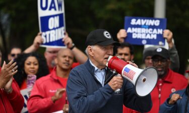 US President Joe Biden addresses striking members of the United Auto Workers (UAW) union at a picket line outside a General Motors Service Parts Operations plant in Belleville