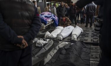 Palestinians gather around the bodies of those who were killed in the Israeli ground offensive and bombardment of Khan Younis