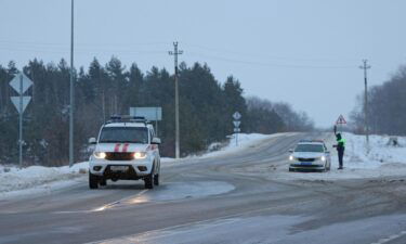 Traffic police officers block off a road near the crash site of the Russian Ilyushin Il-76 military transport plane outside the village of Yablonovo in the Belgorod region of Russia on January 24.