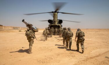 US Army Soldiers board a CH-47 Chinook helicopter after a live-fire exercise at Al Asad Air Base