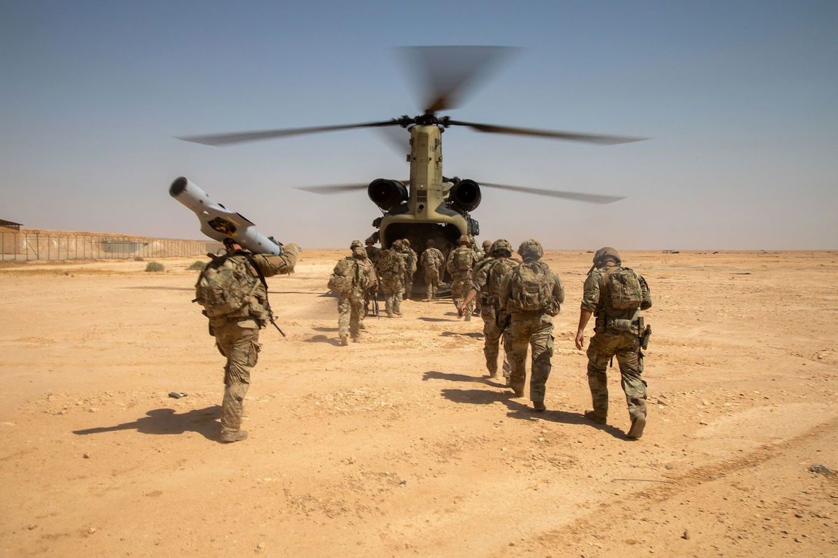 <i>Spc. Timothy VanDusen/US Army</i><br/>US Army Soldiers board a CH-47 Chinook helicopter after a live-fire exercise at Al Asad Air Base