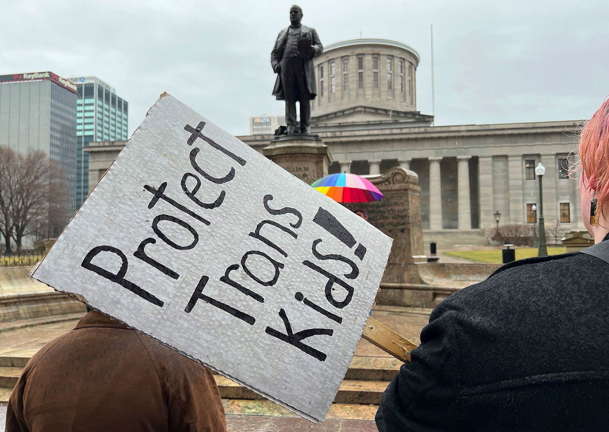 <i>Patrick Orsagos/AP</i><br/>Protesters advocating for transgender rights and healthcare stand outside of the Ohio Statehouse on Wednesday