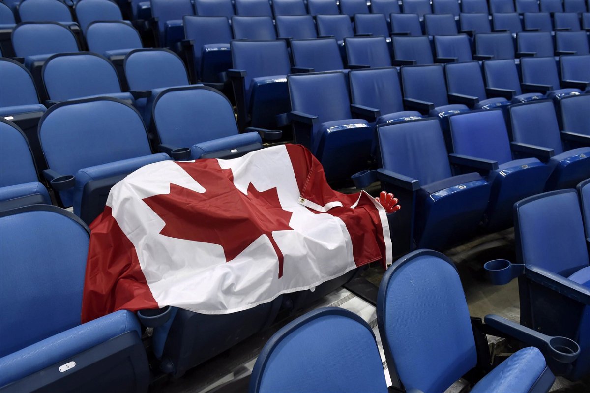 <i>Nathan Denette/AP</i><br/>A Canadian flag sits on a pair of seats reserved for fans at a World Junior Championship hockey game in January 2018 in Buffalo