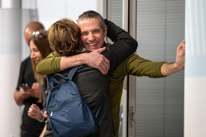 Fernando Simon Marman reunites with a loved one at Sheba Medical Center, in Ramat Gan, Israel, on Monday.