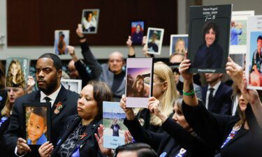 People hold up photographs and placards during the Senate Judiciary Committee hearing on online child sexual exploitation at the U.S. Capitol in Washington