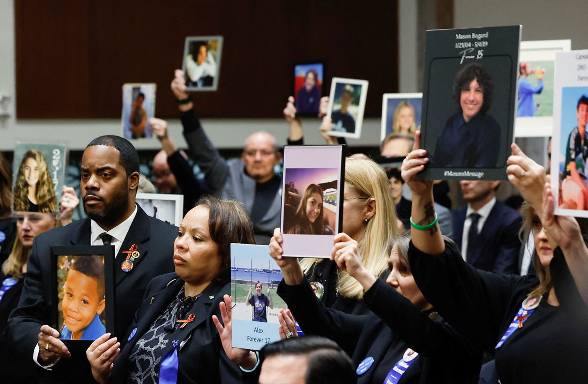 <i>Evelyn Hockstein/Reuters</i><br/>People hold up photographs and placards during the Senate Judiciary Committee hearing on online child sexual exploitation at the U.S. Capitol in Washington