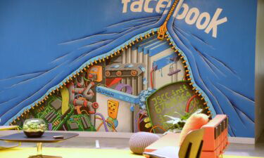 A mural decorates one of the many open work areas at Facebook headquarters in Menlo Park