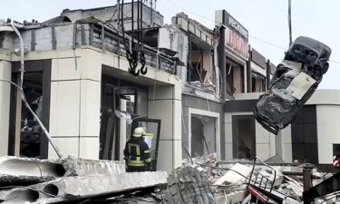 Russian Emergency Ministry employees work at the side of a collapsed bakery in Lysychansk.