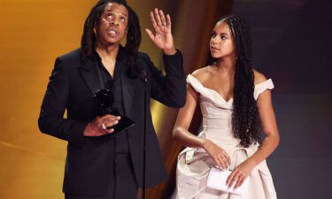 Jay Z accepts the Dr. Dre Global Impact Award as his daughter Blue Ivy Carter looks on during the 66th Annual Grammy Awards.
