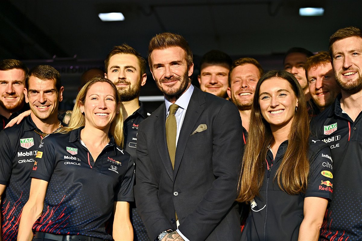 <i>Clive Mason/Getty Images</i><br/>David Beckham and Porter (right) pose with the Red Bull team ahead of the Qatar Grand Prix in 2021.