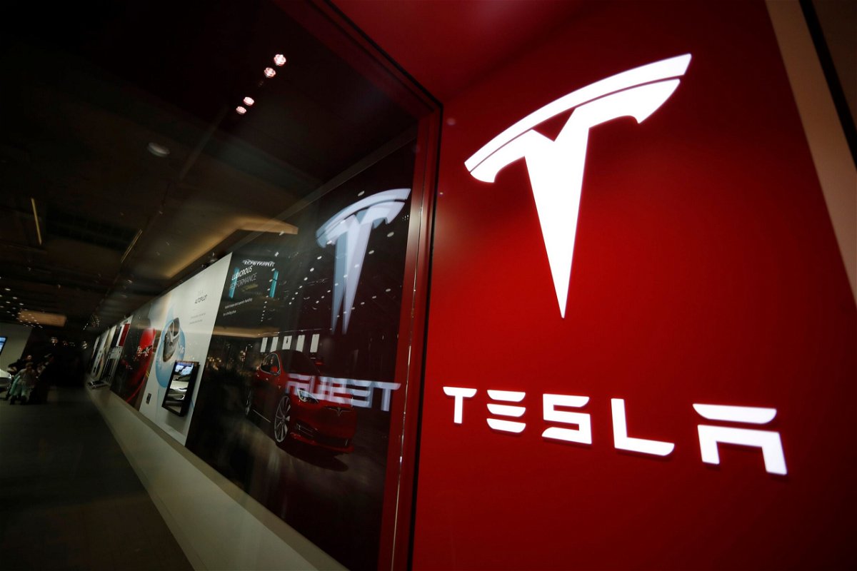 <i>David Zalubowski/AP</i><br/>A sign bearing the Tesla company logo is displayed outside a Tesla store in Cherry Creek Mall in Denver
